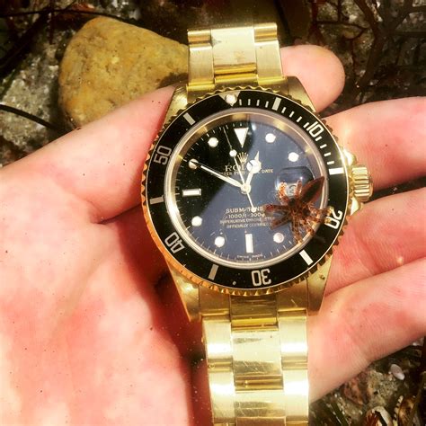 gold rolex with black face.